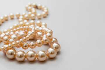 White pearls on the gray background, isolated. Abstract fashion background.