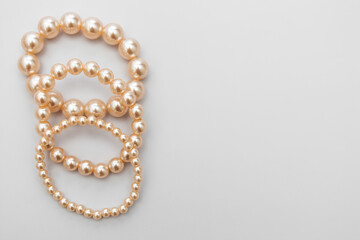 White pearls on the gray background, isolated. Abstract fashion background.