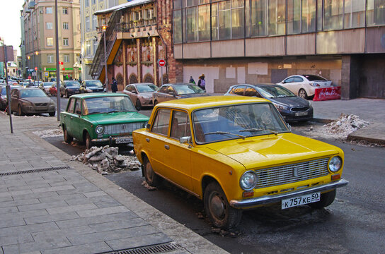 Moscow, Russia - March 17, 2018: Green and yellow soviet motor cars VAZ 2101 Zhiguli standing on the Arbat in Moscow