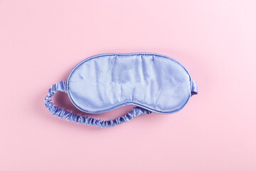 Top view shot of sleeping mask isolated on bright background. Close up, copy space, flat lay.