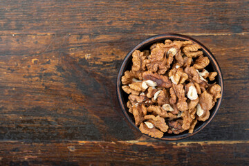 Peeled walnut in a clay bowl.