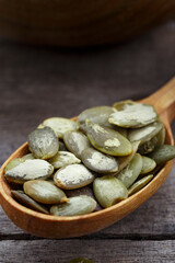Raw pumpkin seeds, food background, top view