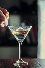 glass of martini and lemon spray