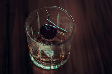 fancy drink with cherry on top of ice