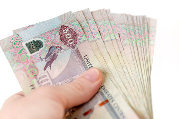 UAE dirhams in hand, banknotes of five hundred, closeup