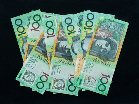 Australian currency 100 dollar notes on black background