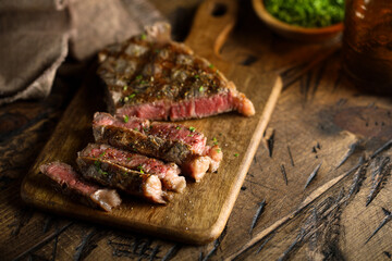 Roasted beef steak on a wooden desk