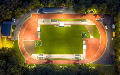 Poster Aerial view of running track at night © creativenature.nl