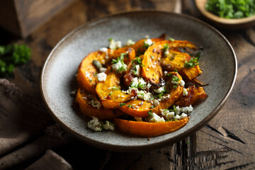 Healthy roasted pumpkin with cheese and herbs