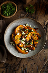 Healthy roasted pumpkin with cheese and herbs