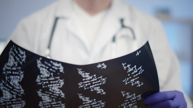 Close up of doctor in robe with stethoscope study x-ray shot of dna chain