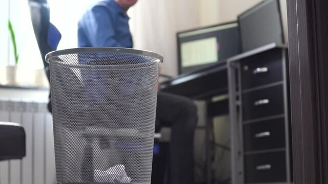 Office Employee Tossing Away Crumpled Paper Into Trash Can. Loafer At Office, Businessman Throws Papers In Trash Can