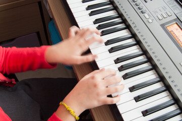 Fototapeta premium background with hands playing an electronic musical keyboard