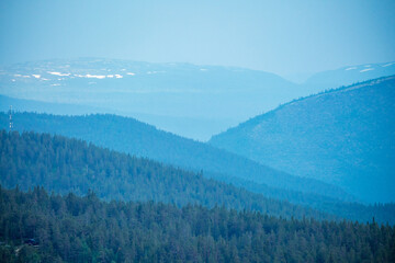 5g signal tower and lots of mountain layers during blue hour.