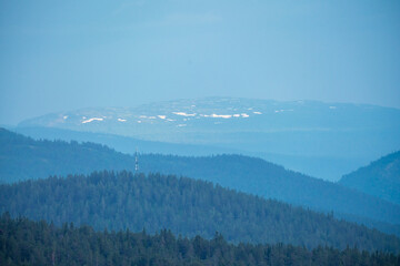 5g signal tower and lots of mountain layers during blue hour.