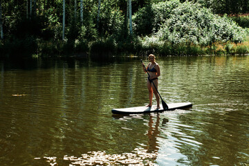 SUP. Stand up paddle. Fun on the lake a hot summer day.