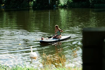 Foto op Canvas SUP Stand up paddle. Activity on the lake a hot summer day. © SteinOve