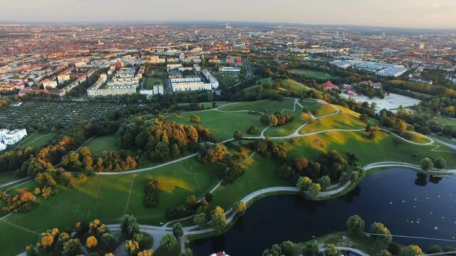 Aerial view of Munich City, Olympia Park with green grass field in summer from Olympiaturm (Olympic Tower) in Munich, Germany before sunset