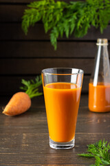 Natural carrot juice with pulp sugar-free in glasses on a wooden table
