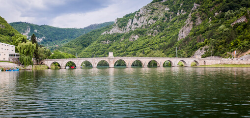 Fototapeta na wymiar Historic bridge over the Drina River, Famous Tourist Attraction, The Mehmed Pasa Sokolovic Bridge in Visegrad, Bosnia and Herzegovina