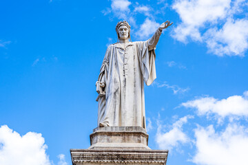 Outdoor statue of Dante Alighieri erected in 1865 to celebrate the 600 year anniversary of the birth of the poet Dante. Monument to Dante Alighieri located in Dante Square, Naples, Italy