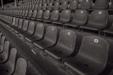 Empty sports stadium seats, no fans, no people, vintage retro style black and white photo