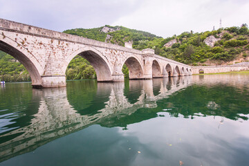 Fototapeta premium Historic bridge over the Drina River, Famous Tourist Attraction, The Mehmed Pasa Sokolovic Bridge in Visegrad, Bosnia and Herzegovina