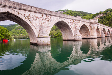 Fototapeta premium Historic bridge over the Drina River, Famous Tourist Attraction, The Mehmed Pasa Sokolovic Bridge in Visegrad, Bosnia and Herzegovina