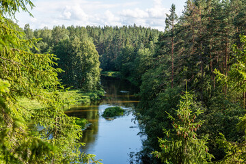 Fototapeta na wymiar View to the river Salaca from high sandstone cliff in Skanaiskalns (Skaņaiskalns) Nature park in July in Mazsalaca in Latvia