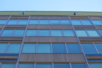 Fototapeta premium Abstract close up of a Mid-century vintage office building with a blue sky