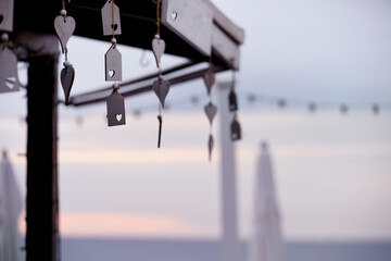 Gentle calm early morning by the sea. Covered umbrellas and a gazebo on the beach.