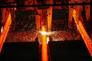 Steel billets at torch cutting in metallurgical plant. Metallurgical production, heavy industry, engineering, steelmaking.