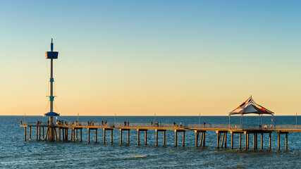 Iconic Brighton Jetty with people at sunset, South Australia