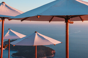 umbrellas sunset over the sea 