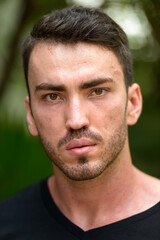 Fototapeta premium Face of handsome bearded man in the park outdoors
