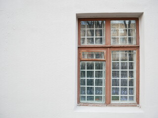 Old wooden window with metal grid.