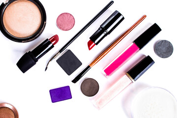lipstick, eye shadow, makeup brushes on a white background