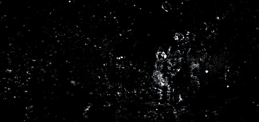 Splashes and drops of water are on a black background.
