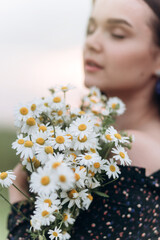 Beautiful brunette woman natural face casual female portrait lifestyle beauty girl with chamomile flowers
