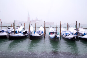 Venice in snow with gondolas on Grand Canal, Riva degli Schiavoni, Grand Channel, St. Mark square, San Giorgio island, snowing in Venice, Italy, march 2018, long exposure