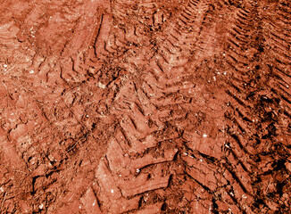 Traces of a truck on red soil.