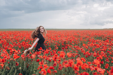 Beautiful happy blondie woman natural face blondie hair casual female portrait in red poppy field