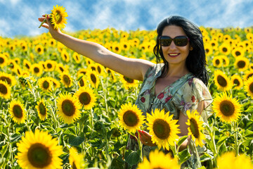 Joyful woman in sunflowers field