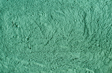 Green cosmetic clay powder (kelp facial mask, spirulina body wrap) texture close up, selective...
