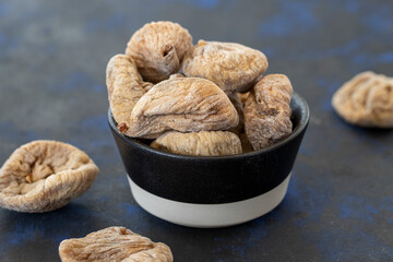 raisin figs in bowl on black background