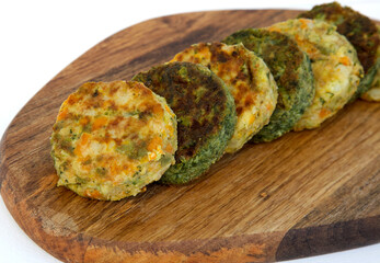 Carrot vegetable cutlets and broccoli on a wooden cutting board