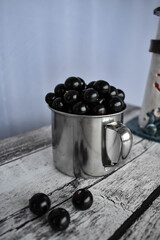 blackcurrant in a mug on a gray table