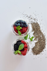 two glasses of delicious homemade smoothie, dessert made from chia and berries. delicious milkshake, vegan raw food. Healthy food and breakfast. Good morning.Selective focus