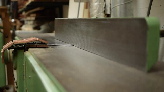 Carpenter planing of board on machine