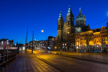 Fototapeta na wymiar View of Basilica of Saint Nicholas at night time, near the Central railway Station,Amsterdam, Netherlands